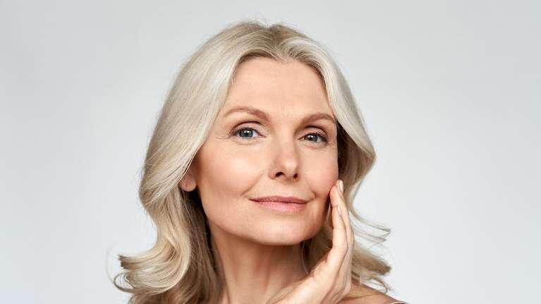 A blonde woman smiling after a Natural Skin Rejuvenation treatment in Rutland, MA.