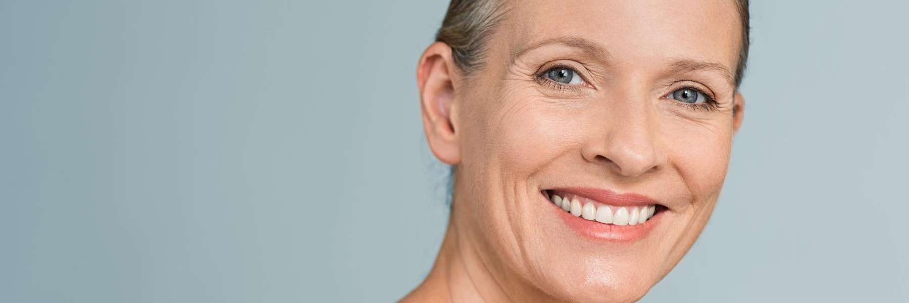 A woman smiling after a Natural Skin Rejuvenation treatment in Rutland, MA.