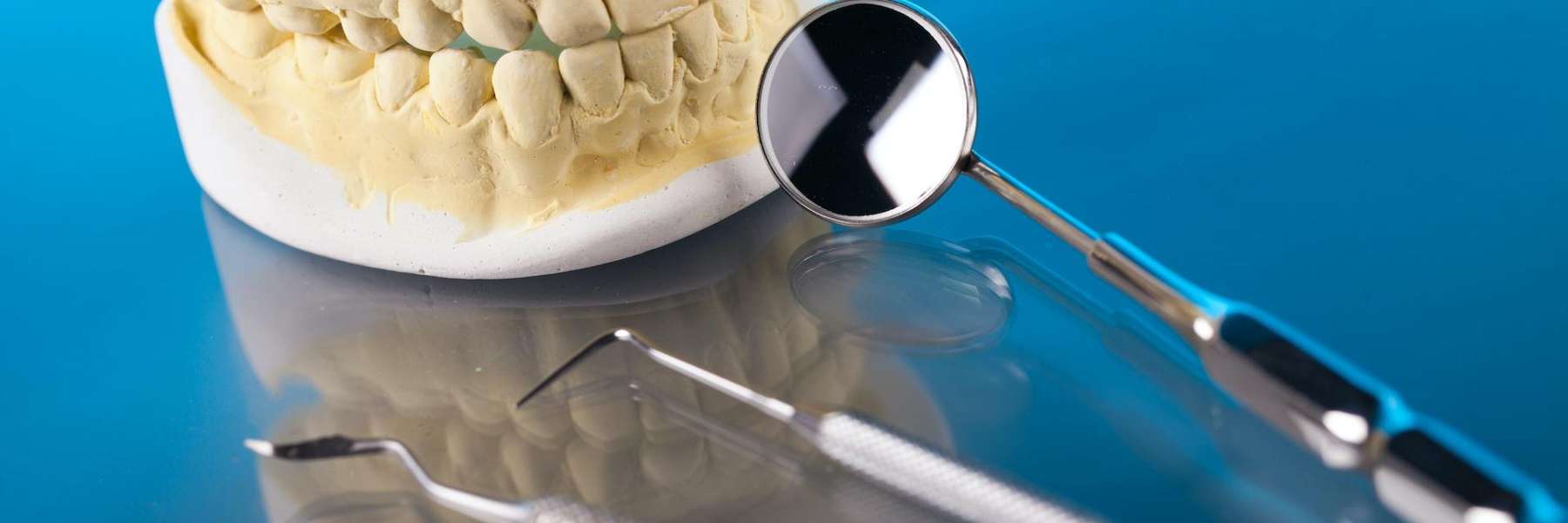 Molded teeth and dental materials on a glass table in Rutland