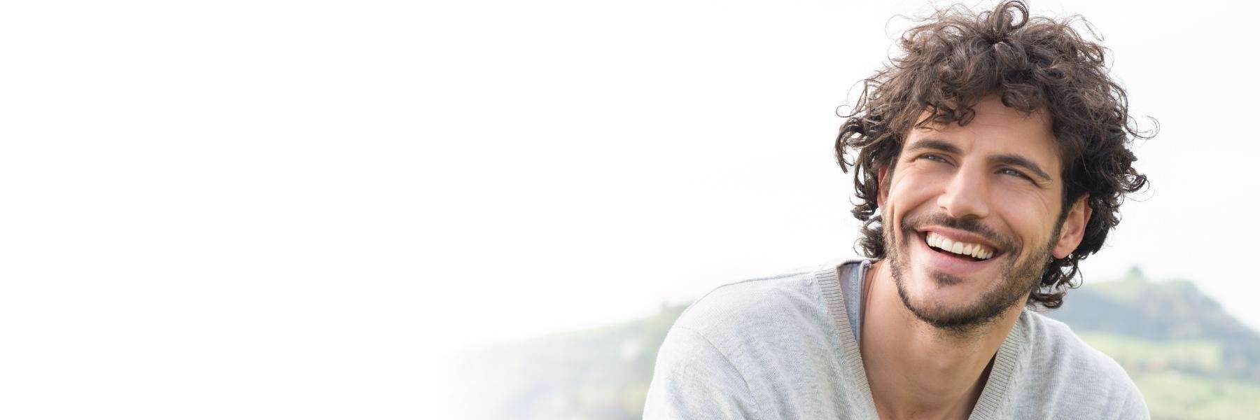 A man smiling after getting teeth whitening treatment in Rutland, MA.