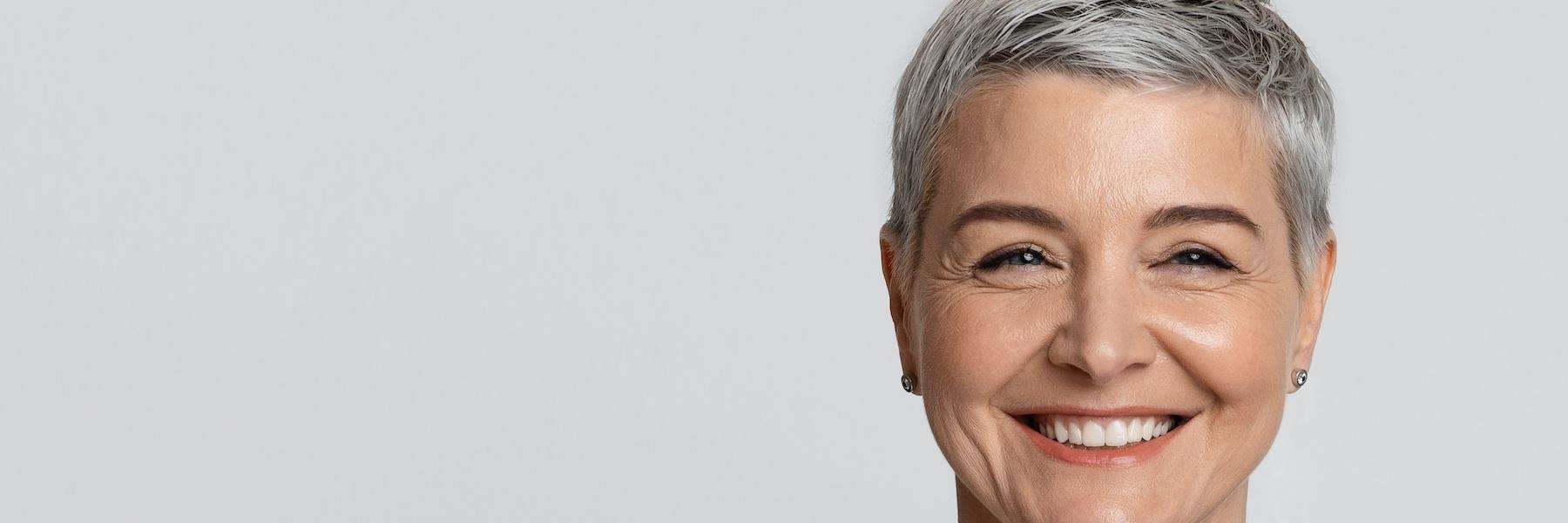 woman smiling after denture treatment